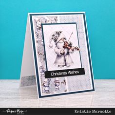 a christmas card with an angel holding a violin on it's shoulder and the words, christmas wishes