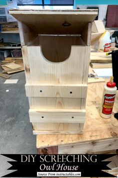 an unfinished bird house with the words diy stretching out