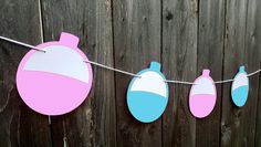 some pink and blue items are hanging on a line