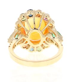 6.74 Carat Fire Opal, Sapphire, Emerald, and Diamond Cocktail RingThis exquisite ring showcases a stunning 3.60 carat Natural Oval Cut Fire Opal, beautifully encircled by vibrant Natural Round Cut Multicolor Sapphires totaling 1.91 carats in a dazzling array of colors. Complementing the design are 0.32 carats of Natural Pear Cut Emeralds and 0.14 carats of Natural Round Cut Diamonds. The clarity and color of the diamonds are SI1 - F. The ring boasts a total carat weight of 6.74 carats.Expertly crafted in 14K yellow gold, this ring weighs approximately 5.4 grams.Sized at 7, this piece can be resized at no extra charge. Item Details: Main Stone: 3.60 carat Oval Cut Fire OpalSurrounding Stones: 1.91 carats of vibrant Round Cut Sapphires 0.32 carats of Emeralds 0.14 carats of Natural Round Cut Luxury Multicolor Rings With Center Stone, Luxury Multicolor Rings With Prong Setting, Formal Multicolor Opal Ring, Elegant Multicolor Sapphire Ring With Center Stone, Elegant Multicolor Opal Ring, Yellow Gold Cocktail Ring, Gold Cocktail, Sapphire Diamond, Pear Cut