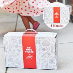 a woman in a red and white polka dot dress is walking past a suitcase on the sidewalk