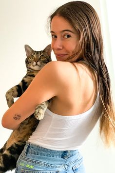 a woman holding a cat in her arms