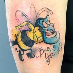 a tattoo on the leg of a person with a bee