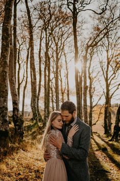 a man and woman embracing in the woods