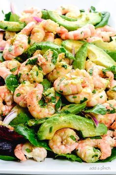 shrimp salad with avocado and cucumbers on a white plate