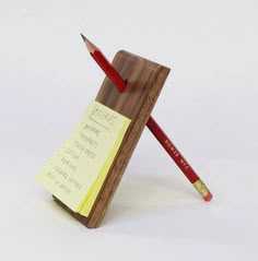 a pen holder with a pencil and sticky note attached to it