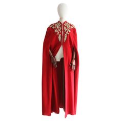 The most majestic and eye-catching cape you could ever set your eyes upon. Rendered in vibrant shade of red wool and decorated with cream wool soutache embroidery, edged with gold lamé soutache embroidery, in a trailing floral design, and finished with claw set silver rhinestones, this original early 1940's piece is sure to bring cheer to your seasonal wardrobe. The soft V shaped neckline of the cape is framed by a simple slopping shoulder line, accented by shoulder pads along each shoulder seam Luxury Red Winter Cape, Soutache Pattern, Soutache Embroidery, Embroidered Cape, Seasonal Wardrobe, Shade Of Red, Gold Lame, Color Crema, Witchy Woman