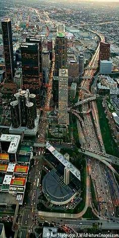 an aerial view of a city with lots of tall buildings and cars on the road