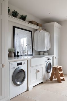 a washer and dryer in a white laundry room