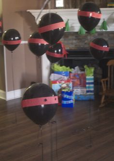 some black and red balloons in the middle of a room with a fire hydrant