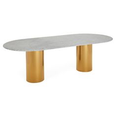 an oval table with gold legs and a white marble top, against a white background