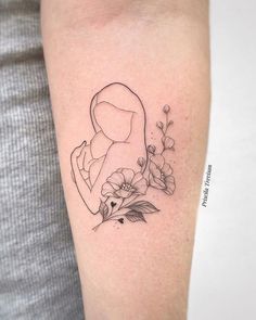 a woman's arm with flowers and a tattoo design on the left side of it