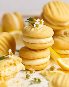 some lemon cookies are stacked on top of each other and one has a flower in the middle