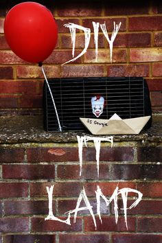 a red balloon floating over a brick wall next to a mailbox with the word diy on it