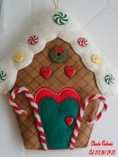 a gingerbread house ornament with candy canes and candies on it