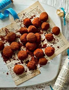 chocolate truffles with sprinkles on an old book and blue ribbon