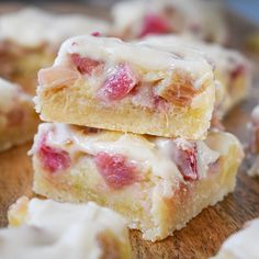 two pieces of cake sitting on top of a wooden cutting board