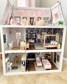 a doll house with furniture and accessories inside