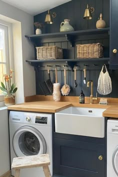 a washer and dryer in a small room with open shelving on the wall