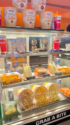 a display case filled with lots of different types of foods and drinks on top of it