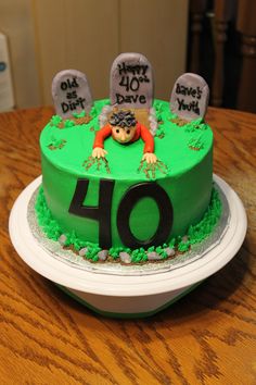 a green birthday cake with the number forty on it