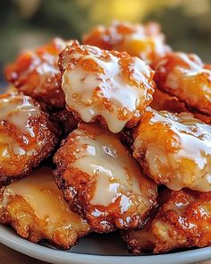 a plate filled with glazed donuts covered in icing