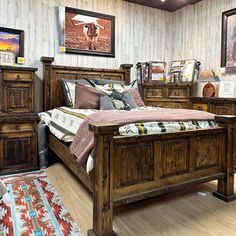 a bed room with a neatly made bed and pictures on the wall