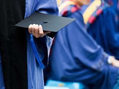 a group of people in graduation gowns and caps