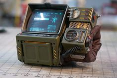 an old fashioned tv sitting on top of a wooden table next to a brown glove