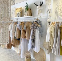 a room filled with lots of different types of clothing hanging on the walls and shelves