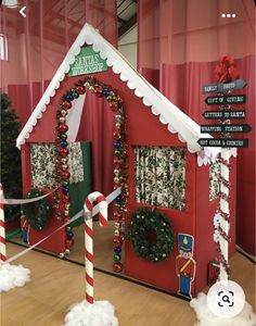 a christmas themed house with candy canes on the floor