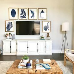 a living room filled with furniture and pictures on the wall above it's entertainment center