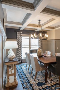 a dinning room table with chairs and a rug on the floor