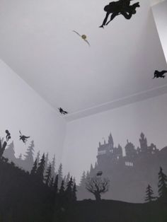 a room with some black and white wallpaper on the walls, and silhouettes of birds flying in the air