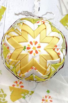 an ornament with yellow and white flowers on it