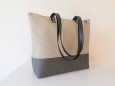 Vegan leather colorblock charcoal gray and light gray everyday casual large simple zippered tote bag with real leather handles, six slip pockets inside and polka dot cotton lining. The bag is available in two sizes: - MEDIUM SIZE: Width on top - 17Wx14Hx5bottom - EXTRA LARGE SIZE: 21Wx14Hx8 bottom * Exterior: - Bottom - high quality vegan leather in gorgeous grafitti grey color -Top - high quality very durable vegan leather in beautiful dove grey color. * Interior: - Natural cotton polka dot lin Gray Large Capacity Laptop Bag For Everyday Use, Large Capacity Gray Laptop Bag For Everyday, Everyday Large Capacity Gray Laptop Bag, Gray Tote Shoulder Bag For Everyday Use, Gray Bags With Leather Handles For Everyday Use, Gray Bags With Leather Handles, Modern Gray Shoulder Bag For Everyday Use, Modern Gray Shoulder Bag With Leather Handles, Modern Gray Everyday Shoulder Bag