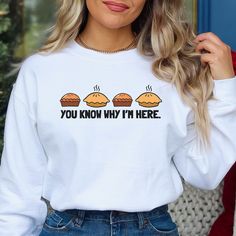 DESIGN: You Know Why I'm Here Sweatshirt, This funny pie shirt for Thanksgiving is perfect for family reunions and holiday parties at any time of year! Imagine how fun this would be to give as a gift for a pie lover. STYLE: Unisex cut flattering for men and women. This shirt feels soft and lightweight, with the right amount of stretch.  SIZING: Please refer to the sizing chart. This is a looser fit for women, go down a size if you would like a tighter fit--but refer to the sizing chart for more accuracy. If you have a favorite t-shirt, lay it flat and measure the width and the length, then compare those measurements to the sizing chart to get the perfect fit for your new t-shirt.  Since each order is custom printed, I cannot accept returns or exchanges if you order the wrong size. AVAILABL White Long Sleeve Tops With Funny Text, White Sweatshirt With Funny Print, Pie Shirt, Yellow Crew Neck T-shirt With Funny Text, Trendy Yellow T-shirt With Funny Print, Fall Novelty T-shirt With Funny Print, Funny Long Sleeve Halloween T-shirt, Thankful Shirt, Funny Thanksgiving