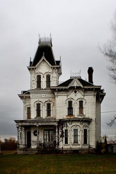 an old house sitting on top of a lush green field