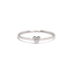 Engrave your initial with a loved ones initial onto this modern tiny heart ring. It's perfect as a couples and friendship gift. Please write the 2 initials you would like to engrave on the Notes box in the Shopping Cart. .925 Sterling Silver Laser Engraving Hypoallergenic, lead and nickel free Heart Height 3.5mm Band 1mm #R108