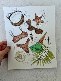 a hand holding up a card with various items on it, including shells and starfish