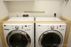 two washers are sitting side by side in front of each other