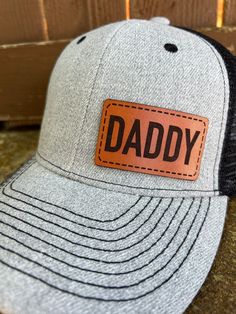 Looking for something different to buy your Daddy?  Gift one of our custom made hats to the Daddy in your life! You get to choose the color of hat, and then we make the Genuine Leather Daddy patch in house from only the finest leather. These hats are custom to our shop and we make them when you order!  Make sure and browse our selection of women's hats too! Quality and Customer Service are our Top Priority, so please message us with any questions! We are a new shop on Etsy, but we are an established small business in McKinney, TX. Feel free to look at our FB page for a wide range of our work. https://www.facebook.com/restoringwithlove/ Font: Daddy will be in the font shown in the pictures unless you message us prior to ordering and request something different. Hats: Choose the hat color yo Brown Trucker Hat With Letter Print, Personalized Casual Trucker Hat For Father's Day, Customizable Black Trucker Hat For Father's Day, Black Trucker Hat For Father's Day With Curved Bill, Adjustable Black Trucker Hat For Father's Day, Black Trucker Hat For Father's Day Gift, Casual Personalized Flat Bill Trucker Hat, Customizable Trucker Hat For Father's Day, Personalized Flat Bill Trucker Hat For Father's Day