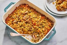 a casserole dish with meat and vegetables in it on a marble table top