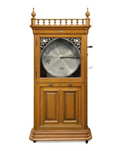 An extraordinary and rare 17 disc coin-operated Regina Sublima upright music box Oak Cabinet, Glazed Glass, Box Company, Sand Toys, Coin Operated, Music Boxes, Oak Cabinets, Antique Wall Clock, Glass Panel