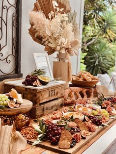 a wooden table topped with lots of different types of food and snacks on it's sides