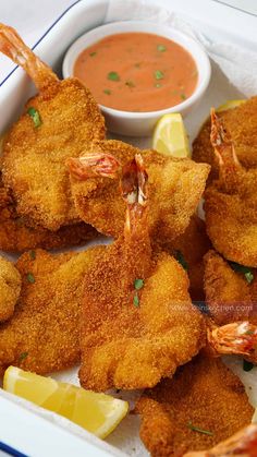 fried shrimp sticks with dipping sauce and lemon wedges