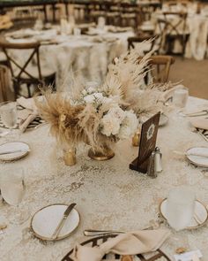 the table is set with silverware, plates and place settings for an elegant wedding reception