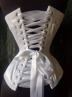 Quality construction and top end materials make my beautiful hand crafted corsets second to none. Designed to embrace your curves perfectly this heirloom corset will be the perfect romantic traditional piece for your wedding trousseau Please supply Full bust and cup size Waist at smallest Hip at widest Allow 4-6 weeks until shipping Fitted Overbust Corset With Boning, Wedding Corset Dress With Satin Finish, Overbust Corset With Boning And Fitted Bodice, Satin Overbust Corset Dress With Corset Back, Satin Corset Dress With Boned Bodice For Debutante Ball, Elegant Corset Belt With Boning And Sweetheart Neckline, Elegant Corset With Satin Finish And Fitted Bodice, Satin Corset With Boning And Sweetheart Neckline, Satin Finish Fitted Corset Dress For Wedding