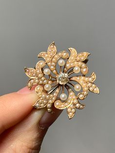 "Crafted and signed by Crane & Theurer. Rendered in 14K gold, centered with a 0.40 carat glimmering OMC diamond. Each flower pedal is pedaled with teensy tiny lustrous seed pearls. There is a articulating bale in the back to switch back and forth between a brooch and pendant. Measurement of Brooch: 2.9 cm by 2.9 cm Carat Weight of Diamond: 0.40 Carats Gold Purity: 14K Gold (Acid Tested) Stamps: \"14K\" Crane and Theurer Makers Mark" Luxury Yellow Gold Wedding Brooches, Yellow Gold Diamond Brooch Fine Jewelry, Diamond Yellow Gold Brooches Fine Jewelry, Exquisite Diamond Brooches In Yellow Gold, Exquisite Yellow Gold Diamond Brooches, Yellow Gold Diamond Brooches Fine Jewelry, Yellow Gold Diamond Brooch In Fine Jewelry Style, Exquisite Yellow Gold Brooch For Anniversary, Luxury Gold Brooches With Rose Cut Diamonds