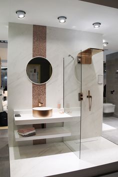 a bathroom with a stand up shower, sink and mirror on the wall next to it